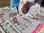 A vendor sells newspapers with headlines about the news of the ousted prime minister Sheikh Hasina in Bangladesh.