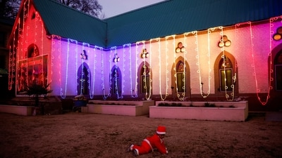 A child dressed up as Santa Claus plays outside Srinagar's Holy Family Catholic Church after Mass on Christmas Eve. (Sharafat Ali/Reuters)