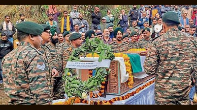 Army personnel pay tributes to the mortal remains of JCO Surjeet Singh at his native village in Reasi on Thursday. (PTI)