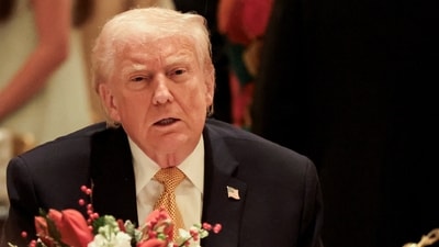 US President Donald Trump takes part in a Christmas Eve dinner in the ballroom of his Mar-a-Lago club in Palm Beach, Florida. (REUTERS)