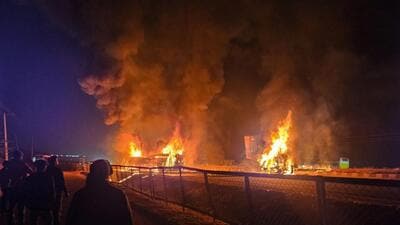 Flames and smoke billow out after a bus caught fire following a collision with a speeding truck, in Chitradurga, early Thursday. (PTI) Flames and smoke billow out after a bus caught fire following a collision with a speeding truck, in Chitradurga, early Thursday. (PTI)