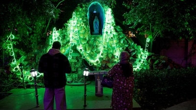 Devotees overlook Christmas decorations at the Holy Family Catholic Church on Christmas Eve in Jammu and Kashmir's Srinagar. (Sharafat Ali/Reuters)