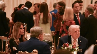 Trump and first lady Melania Trump can be seen sitting together at a Christmas dinner at his Mar-a-Lago resort in Palm Beach, Florida, on December 24, 2025. (Photo by ANDREW CABALLERO-REYNOLDS / AFP) (AFP) Trump and first lady Melania Trump can be seen sitting together at a Christmas dinner at his Mar-a-Lago resort in Palm Beach, Florida, on December 24, 2025. (Photo by ANDREW CABALLERO-REYNOLDS / AFP) (AFP)