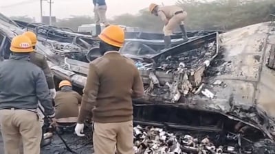 Screengrab of the video showing emergency workers clearing the charred remains of the bus that went up in flames after collision with a lorry on NH-48. (PTI) Screengrab of the video showing emergency workers clearing the charred remains of the bus that went up in flames after collision with a lorry on NH-48. (PTI)