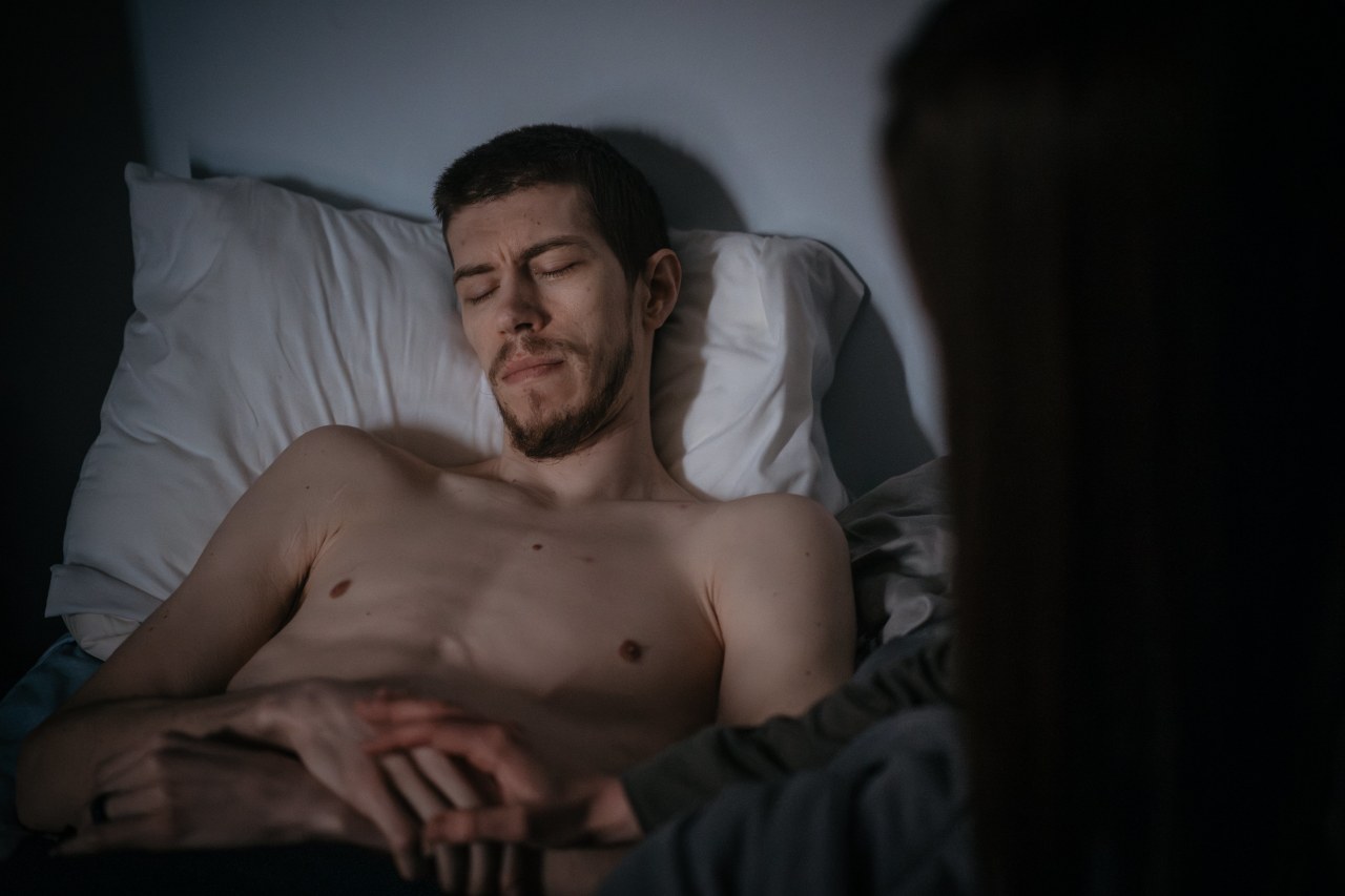 John Avery lies in a dark room at his mother's home. His wife, Lauren Avery, visits every day or two. John Avery lies in a dark room at his mother's home. His wife, Lauren Avery, visits every day or two.