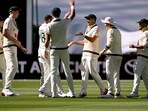 Australia's Scott Boland is congratulated by teammates after taking a catch to dismiss England batsman Brydon Carse. 