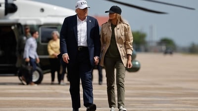 President Donald Trump and first lady Melania Trump visit walk across the tarmac at Lackland Air Force Base after meeting with state and local leaders, first responders and victims of last week's flash flooding on July 11, 2025 in San Antonio, Texas. (Getty Images via AFP) President Donald Trump and first lady Melania Trump visit walk across the tarmac at Lackland Air Force Base after meeting with state and local leaders, first responders and victims of last week's flash flooding on July 11, 2025 in San Antonio, Texas. (Getty Images via AFP)