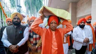 Uttar Pradesh chief minister Yogi Adityanath carries the Guru Granth Sahib on his head on the occasion of Veer Bal Diwas, in Lucknow on Friday. (ANI PHOTO) Uttar Pradesh chief minister Yogi Adityanath carries the Guru Granth Sahib on his head on the occasion of Veer Bal Diwas, in Lucknow on Friday. (ANI PHOTO)