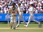 Australian batsman Travis Head (L) smiles after he was dismissed. 