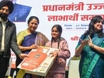 Chief minister Rekha Gupta gives a gas connection to a woman under the Pradhan Mantri Ujjwala Yojana at Thyagraj Stadium in New Delhi on Saturday. (RAJ K RAJ /HT PHOTO)