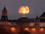 The Beaver Moon, a type of supermoon, sets behind the Kremlin in Moscow, Russia.