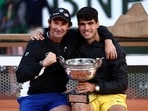 Carlos Alcaraz celebrates with coach Juan Carlos Ferrero after winning the 2024 French Open.
