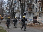 Emergency responders leave the site of an apartment building that was hit by a Russian drone, amid Russia's attack on Ukraine.