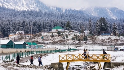 Baramulla: Tourists stroll as a thick white layer blankets the Gulmarg area after the season's first snowfall, in Baramulla, Wednesday, Nov. 5, 2025. (PTI Photo/S Irfan)(PTI11_05_2025_000219B) (PTI)