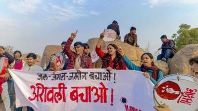 Students display banners during a protest for protection of the Aravalli Hills at Jawaharlal Nehru University on Saturday. (PTI)