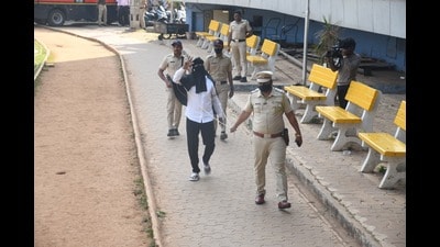 With face covered using a black cloth and hands tied, local gang leader Bandu Andekar filed his nomination for the upcoming civic polls in Pune amid police security. (MAHENDRA KOLHE/ HT)