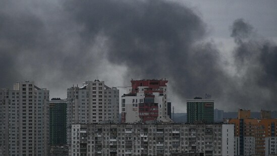 This photograph taken on December 27, 2025 shows smoke rising above residential buildings following Russian drones and missiles attack, in Kyiv, amid the Russian invasion in Ukraine. (AFP)