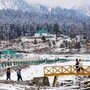 Baramulla: Tourists stroll as a thick white layer blankets the Gulmarg area after the season's first snowfall, in Baramulla, Wednesday, Nov. 5, 2025. (PTI Photo/S Irfan)(PTI11_05_2025_000219B)
