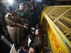 A senior Police officer speaks to the congress leader Mumtaz Patel and the members of the "People against Rapes in India" organisation during the protest, demanding justice for the Unnao gangrape victim and Ankita Bhandari, outside the Parliament House, in New Delhi on Saturday. 