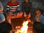 People sit near the bonfire to protect themselves from the cold wave and foggy weather near Ramlila Maidan in New Delhi. (Photo by Arvind Yadav/ Hindustan Times) People sit near the bonfire to protect themselves from the cold wave and foggy weather near Ramlila Maidan in New Delhi. (Photo by Arvind Yadav/ Hindustan Times)