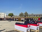 Libyan officials and military personnel receive the coffins of the Libyan chief of staff and his four advisers, who were killed in a plane crash in Turkey, during an official repatriation ceremony at the Ministry of Defence headquarters in the Libyan capital Tripoli, on December 27, 2025.