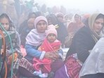 People attending a religious event amid foggy weather in Ranjit Avenue of Amritsar on Saturday. (Sameer Sehgal/HT)