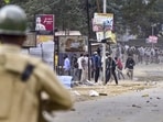 People pelt stones during a clash between two groups over the issue of eviction at Kheroni in West Karbi Anglong district of Assam on December 23. (PTI)