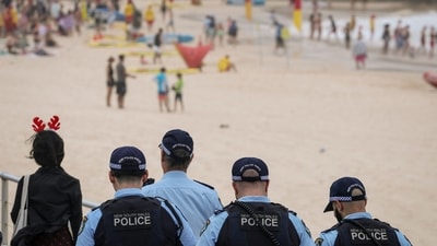 Police officers patrol near beachgoers on Christmas Day at Bondi Beach in Sydney. (AFP) Police officers patrol near beachgoers on Christmas Day at Bondi Beach in Sydney. (AFP)