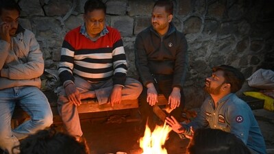 People sit near the bonfire to protect themselves from the cold wave and foggy weather near Ramlila Maidan in New Delhi. (Photo by Arvind Yadav/ Hindustan Times) People sit near the bonfire to protect themselves from the cold wave and foggy weather near Ramlila Maidan in New Delhi. (Photo by Arvind Yadav/ Hindustan Times)