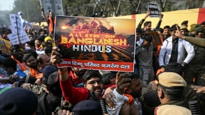 Security personnel try to stop Vishva Hindu Parishad (VHP) activists along with others during a protest march near the Bangladesh High Commission in New Delhi on December 23, 2025, to condemn the killing of Hindu garment worker Dipu Chandra Das. (AFP) Security personnel try to stop Vishva Hindu Parishad (VHP) activists along with others during a protest march near the Bangladesh High Commission in New Delhi on December 23, 2025, to condemn the killing of Hindu garment worker Dipu Chandra Das. (AFP)