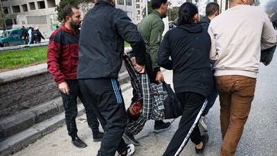 A man seriously injured by a thrown stone is taken away from the area after clashes erupted between Alawite protesters from the Alawite religious minority and counterprotesters, two days after a bomb in an Alawite mosque in Homs killed eight people and wounded 18 during Friday prayers, in Latakia, Syria's coastal region. (AP)