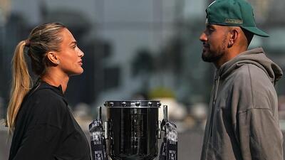 Tennis players Aryna Sabalenka of Belarus, left, and Nick Kyrgios of Australia face-off with the trophy during a press conference ahead of the Battle of the Sexes exhibition match at Atlantis The Royal in Dubai, United Arab Emirates, Saturday, Dec. 27, 2025. (AP Photo/ Fatima Shbair) (AP)