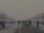 People walk at Kartavya Path as a layer of toxic smog engulfs the area, in New Delhi on Sunday. 