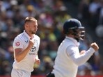 Gus Atkinson (L) celebrates the wicket of Australia's Scott Boland during the second day of the fourth Ashes cricket Test match between Australia and England