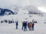 Tourists enjoy after a fresh spell of snowfall in Sonamarg on Monday. (ANI)