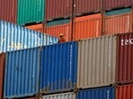 FILE PHOTO: A worker sits on a ship carrying containers at Mundra Port in Gujarat 