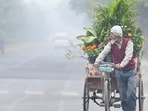 Noida,India-December 22, 2025:Amid rising air pollution levels, A Florist ventured out on a foggy and cool morning, with a blanket of toxic smog covering Delhi-NCR, in Noida, India, on Monday ,December 22, 2025. (Photo by Sunil Ghosh / Hindustan Times)