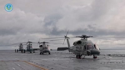 Helicopters on an amphibious assault ship take part in military drills in waters southeast of Taiwan, in this screenshot from a video released by the Eastern Theatre Command of China's People's Liberation Army. (via REUTERS)