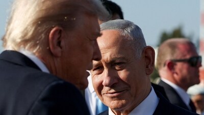 Israeli Prime Minister Benjamin Netanyahu looks on next to US President Donald Trump (REUTERS)