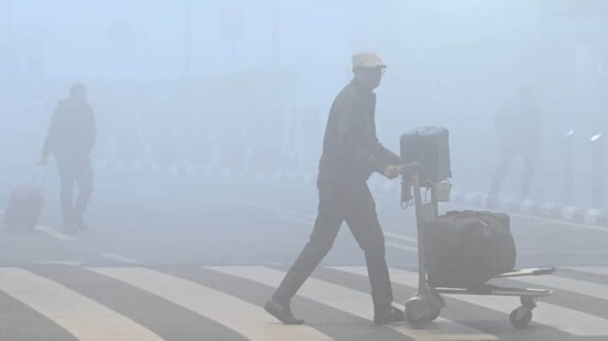 Morning commuters were seen amid the severe winter fog on Monday morning at T1 IGI Airport(Vipin Kumar/Hindustan Times)