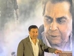 Sunny Deol posing with Dharmendra's poster at Ikkis screening. Sunny Deol posing with Dharmendra's poster at Ikkis screening.