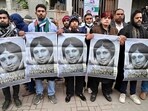 Khaleda Zia death news highlights: Supporters of Bangladesh's late former prime minister Khaleda Zia hold posters with her portrait as they mourn her death outside the Evercare hospital in Dhaka.
