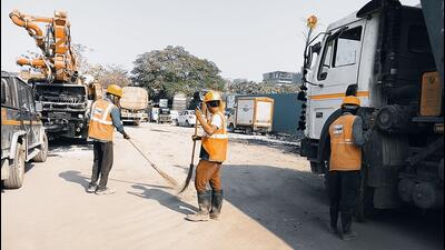 At the Metro 2B site, where ready mix concrete plants are operational, workers were seen sweeping the road At the Metro 2B site, where ready mix concrete plants are operational, workers were seen sweeping the road