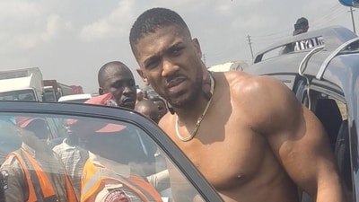Former heavyweight boxing champion Anthony Joshua looks on as he gets into a vehicle following a car accident. (Sodiq Ayo via REUTERS)