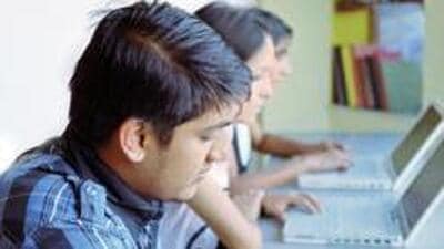 Group of Indian / Asian college students studying in the library using laptop computers. (Getty Images/iStockphoto) Group of Indian / Asian college students studying in the library using laptop computers. (Getty Images/iStockphoto)