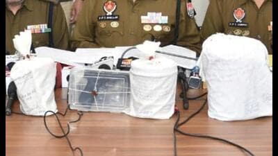 The seized contraband & pistol in Amritsar on Tuesday. (HT) The seized contraband & pistol in Amritsar on Tuesday. (HT)