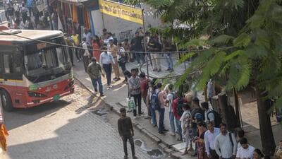 iMumbai, India - December 30, 2025: Commuters standing in a queue for a BEST bus at the spot where a BEST bus accident occurred last night at Bhadup station in Mumbai, India, on Tuesday, December 30, 2025. (Photo by Satish Bate/ Hindustan Times) (Hindustan Times) iMumbai, India - December 30, 2025: Commuters standing in a queue for a BEST bus at the spot where a BEST bus accident occurred last night at Bhadup station in Mumbai, India, on Tuesday, December 30, 2025. (Photo by Satish Bate/ Hindustan Times) (Hindustan Times)