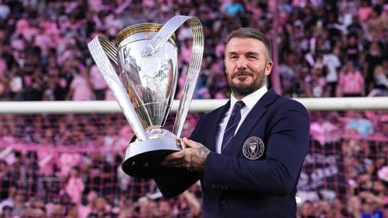 Sir David Beckham poses with Champion's trophy of MLS. (Getty Images via AFP)