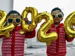 Children pose for a picture by holding a '2026' cutout ahead of New Year celebrations, in Prayagraj on Tuesday.