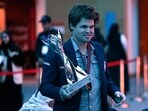 Norway's Magnus Carlsen walks with the winner's trophy after the FIDE World Rapid and Blitz Championship in Doha